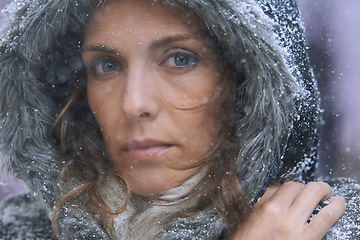 Image showing Snow, woman and portrait in nature with cold climate and weather with winter fashion and idea. Ice, travel and freezing outdoor with a female person in Iceland with frost in a storm with jacket