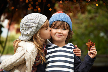 Image showing Children, love and siblings kiss in a park for travel, adventure or bonding on autumn journey in nature. Family, support and kids hug in a forest for explore, playing or fun games in Canada outdoor