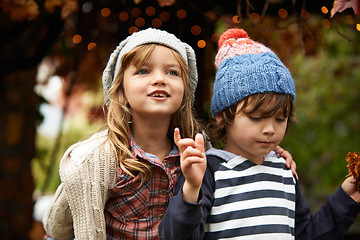 Image showing Children, love and siblings in a park for travel, adventure or bonding on autumn journey in nature together. Family, freedom and kids in a forest for explore, playing or fun discovery games outdoor