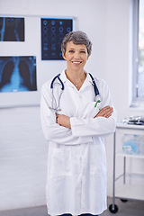 Image showing Senior doctor, woman and arms crossed in portrait, radiology for surgery with anatomy scan and healthcare. Medical professional, treatment and surgeon in room for xray, medicine and confident expert