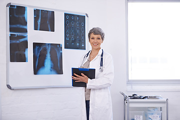 Image showing Doctor, woman and clipboard in portrait, radiology for surgery with anatomy scan and healthcare. Senior medical professional, treatment and surgeon in room for xray, checklist and confident expert