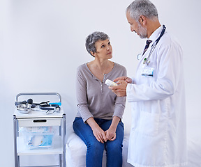 Image showing Hospital, consulting and doctor with medicine for patient prescription, pills and treatment. Healthcare, medication and senior woman in consultation for medical service, wellness and diagnosis