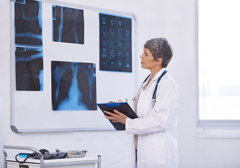 Image showing Senior doctor, woman and study xray with clipboard for checklist, assessment and radiology for surgery. Lungs, brain and bones with anatomy scan for healthcare, surgeon and treatment plan at clinic