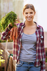 Image showing Happy woman, portrait and farmer with carrots in harvest, garden or farm for crops or resources. Female person with smile and a bunch of roots for organic vegetables, natural growth or sustainability