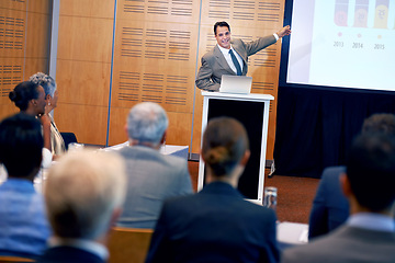 Image showing Businessman, presentation and laptop with projector at conference in team meeting, staff training or seminar. Man, employee or speaker talking on podium to group for corporate growth at workshop