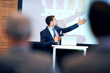 Image showing Business man, presentation and pointing at projector screen, conference or workshop with laptop for slideshow. Corporate training, seminar and speaker with info, audience and professional speech