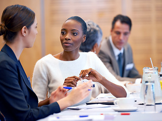 Image showing Woman, meeting and discussion with team in conference for planning, strategy or collaboration at the office. Female person, employees or colleagues talking in boardroom conversation at the workplace