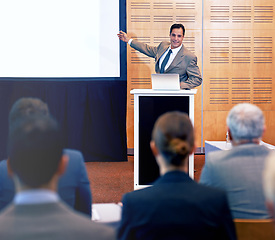 Image showing Conference, speaker and man talking in meeting for business for discussion of stock market. Directors, women and people listening as team of employees in corporate company with presentation.