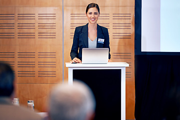 Image showing Business woman, podium and presentation with smile, conference or workshop with laptop for slideshow or PPT. Corporate training, seminar and speaker with info, audience and professional speech