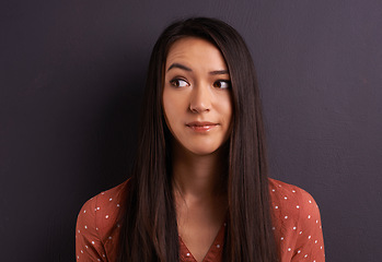 Image showing Thinking, woman and ideas with doubt, decision and confused on a grey studio background. Person, mockup space and girl with a choice or questions with why and thought with solution or problem solving