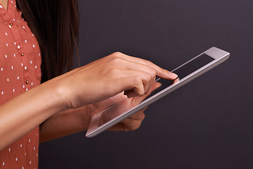 Image showing Hand, tablet and communication with internet connection in studio black background, conversation or streaming. Person, fingers and digital touchscreen for contact us technology, online or mockup