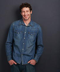 Image showing Portrait, fashion and man with a smile, confidence and stylish clothes on a grey studio background. Face, person and model with casual outfit or cheerful model with pride and joyful with mockup space