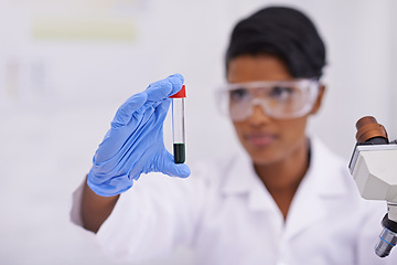 Image showing Blood, hand and scientist with test tube in laboratory for scientific research or experiment. Microscope, science and woman researcher with pharmaceutical dna in glass vial for medical study.