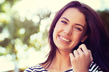 Image showing Woman, portrait and smile with nature, sunshine and park for happiness and wellness. Person, joy and bokeh with closeup, glow and happy for summer relax and adventure outside in garden with trees