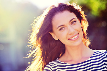 Image showing Woman, portrait and smile with nature, sunrise and park for happiness and wellness. Person, joy and bokeh with closeup, glow and sunshine for summer relax and adventure outside in garden with trees