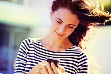 Image showing Outdoor, sunshine and woman with cellphone, typing and sunshine with social media, summer or website info. Smartphone, girl or mobile user with digital app or tech with online reading, blog or news
