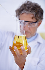 Image showing Science, laboratory and man with liquid in beaker for medical research, analysis and vaccine development. Healthcare, pharmaceutical and scientist with glass test tube for sample, experiment or study