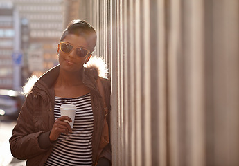 Image showing Street, fashion and portrait of woman with coffee, outdoor and happy, sunglasses and city. Adult, female person and girl with smile with jacket or coat in Cape Town, shades and tea to drink on hand
