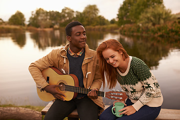 Image showing Camping, guitar and couple by lake in nature on outdoor holiday, vacation and adventure, Campsite, travel and man and woman bonding with musical instrument in woods, forest and countryside together