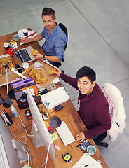 Image showing Business people, men and portrait while eating with top view for deadline, pizza and coworking company. Programmer, teamwork and technology on lunch with fast food, happiness and software development