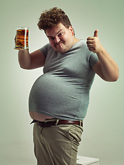 Image showing Plus size, portrait and thumbs up from man with beer for unhealthy habit, stomach and weight gain in studio of white background. Emoji, hand and male person by alcohol, funny face and calories
