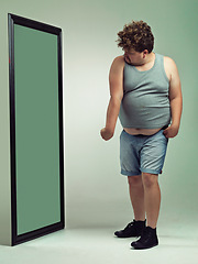 Image showing Man, flex and body image in mirror for eating disorder, anxiety and mental health. Depression, weight gain and insecurity for plus size male person, reflection and muscle and frustrated or sad