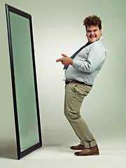 Image showing Mirror, portrait and man with happiness for pointing, excited and smile for reflection in studio. Adult, plus size and male person with comic, guy and positive to change unhealthy diet and life