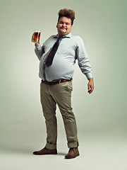 Image showing Plus size, portrait and man with beer in studio to enjoy drinking alcohol from pint glass for fun. Adult, guy and male person with smile, drunk and holding mug with beverage in party for break