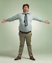 Image showing Studio, happiness and man with arms for freedom in background, positive and joy of living life. Plus size, adult and male person with confidence, pride and professional with suit and guy with smile