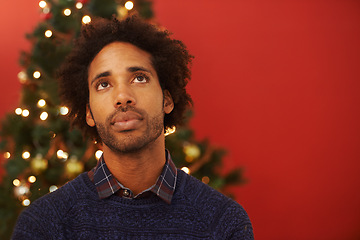Image showing Man, thinking and Christmas holiday at tree for festive season thoughts for present, vacation or celebration. Male person, contemplating and red background with mockup space, decoration or lights