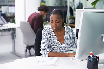 Image showing Computer, research and documents with business black woman at desk in office for company administration. Email, feedback and report on pc with serious young employee in workplace for information