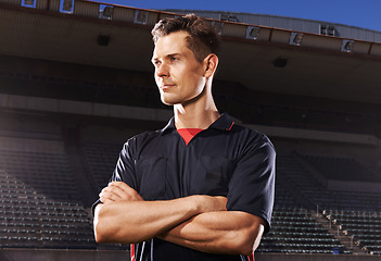 Image showing Man, arms crossed and referee for sport at stadium, personal trainer or coach with determination and focus outdoor. Soccer umpire, challenge and competition at arena with confidence and pride at game