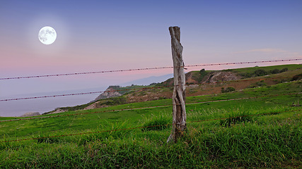 Image showing Hawaii, landscape and hill in countryside with fence, wood and nature with peace for life. Field, meadow and sky with moon, outdoor and location with environment for vacation on holiday to relax