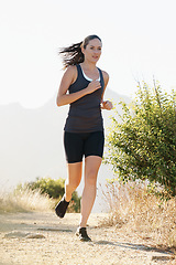 Image showing Runner, woman and running on trail with fitness for sport, training or exercise for competition on mountain. Athlete, person or marathon with wellness, challenge or cardio for healthy body in Denmark