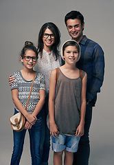 Image showing Parents, kids and happy in studio portrait with pride, care and support with love by background. Mother, father and children with smile for family, kindness and clothes with trendy fashion for style