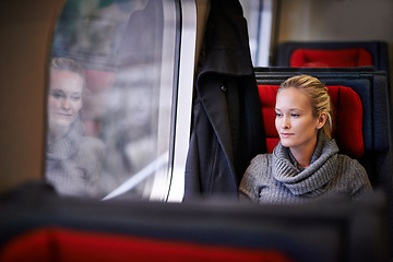 Image showing Woman, travel and thinking on train for vacation with adventure, trip and leisure for journey in France. Female person, commute and holiday on public transport as tourist for break and destination