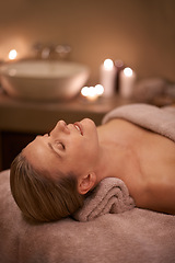 Image showing Blonde woman, massage therapy and candlelight for wellness, smile and relaxation to destress and pamper. Female person, self care and cleanse for detox, spa day and peace for beauty and happiness