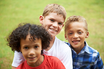Image showing Boys, friends and portrait or smile outdoor in summer with confidence, pride or diversity in nature. Children, face or happy on grass field with embrace for friendship, care and support on playground