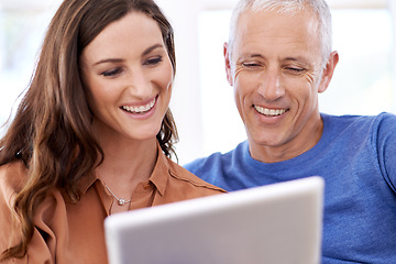 Image showing Couple, tablet and happy in home to relax with reading, search and app to watch movie with bonding. People, woman and mature man on digital touchscreen for notification with web connection in house