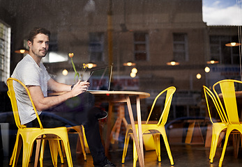 Image showing Young man, thinking and vision with phone at cafe by window for social media or communication at indoor restaurant. Male person on mobile smartphone for online chatting, texting or app at coffee shop