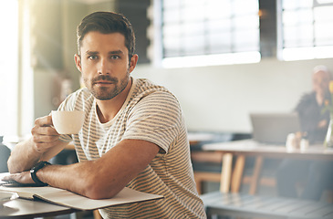 Image showing Man, cup and freelancer portrait in coffee shop, ideas and planning for startup company in cafe. Male person, latte and relax in restaurant for remote work in notebook, contemplating and inspiration