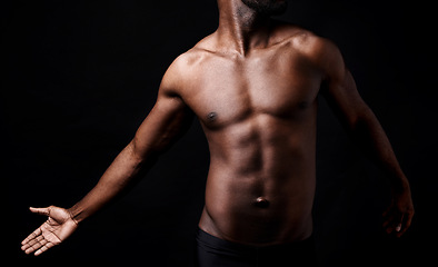 Image showing Black man, fitness and muscle with shadow for exercise or workout on a dark studio background. Closeup of young African male person or bodybuilder with masculine or muscular figure on mockup space