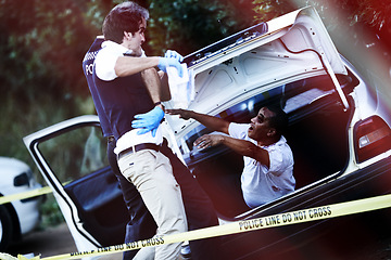 Image showing Policeman, car and zombie at crime scene, horror and monster or scary infected person in trunk of vehicle. Authority, danger and supernatural beast or survivor, rescue and undead person for terror