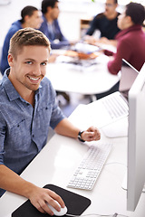 Image showing Business man, computer and working at office desk for web development, programming or information technology. Young programmer, worker or online designer on multimedia, planning and startup project