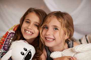Image showing Happy, toys and portrait of children in bedroom for playing, bonding and excited for sleepover in home. Night, friends and young girls on bed in tent or blanket fort for childhood, fun and happiness