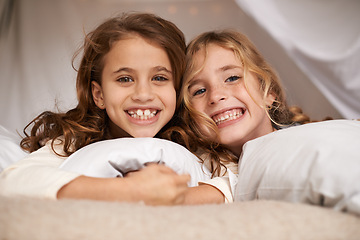 Image showing Excited, sleepover and portrait of children in bedroom for playing, bonding and relax with toys in home. Happy, friends and young girls on bed in tent or blanket fort for childhood, fun and happiness