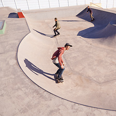 Image showing Sports, friends and men with skateboard, ramp or bowl action at a skate park for stunt training. Freedom, adrenaline and gen z skater people with energy, balance or skill, exercise or performance