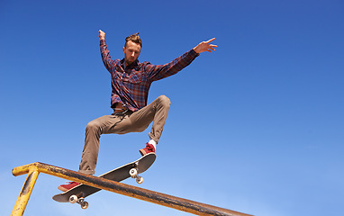 Image showing Fitness, energy and man with skateboard, jump or rail balance at a skate park for stunt training. Freedom, adrenaline and gen z male skater with air, sports or skill practice, exercise or performance