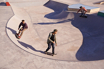 Image showing Friends, sports and men with skateboard, ramp or bowl action at a skate park for stunt training. Freedom, adrenaline and gen z skater people with energy, balance or skill, exercise or performance