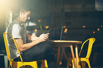 Image showing Man, laptop and relax with phone at cafe for social media, communication or networking at indoor restaurant. Male person sitting on mobile smartphone for online chatting or texting at coffee shop